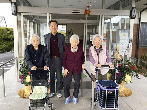 玄関の門松の前で記念写真